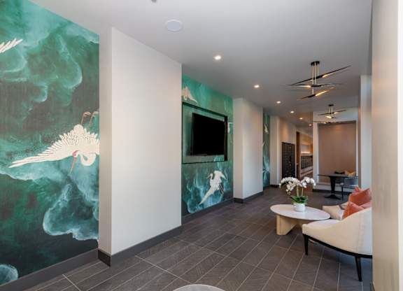 A room with a large painting of a bird on the wall.