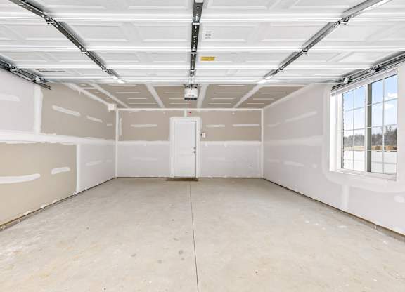 an empty room with white walls and a window