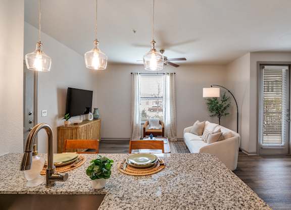 A kitchen with granite countertops and a ceiling fan.