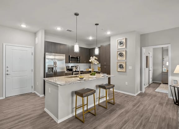 A modern kitchen with a bar stool and a countertop.