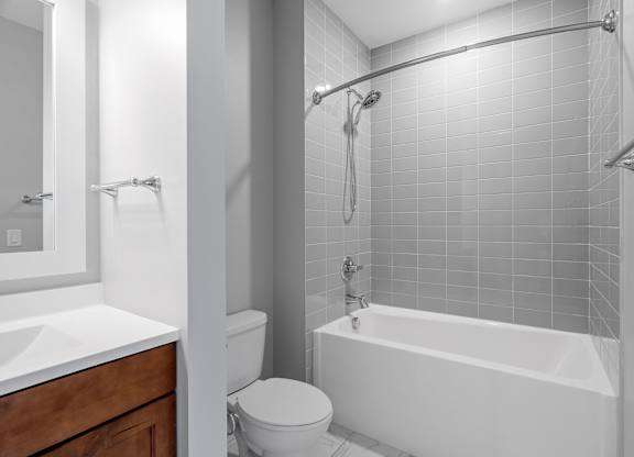 a bathroom with a shower and a toilet and a sink