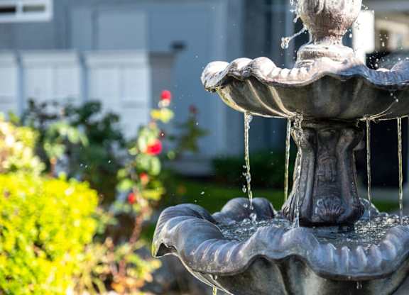 A water fountain with water flowing from it.