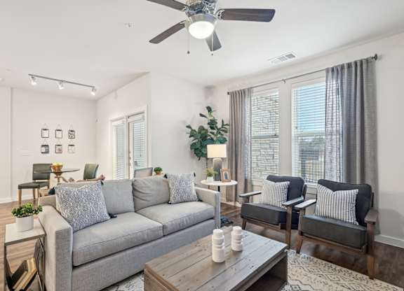 A living room with a grey couch and a wooden coffee table.