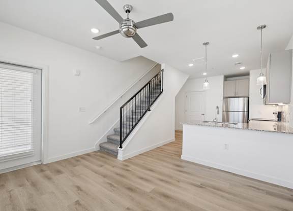 A spacious room with a staircase leading to the upper floor.