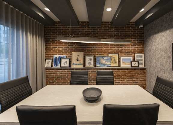 A conference room with a long table and chairs.