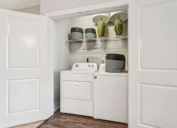 A white bathroom cabinet with a sink and a cabinet door open.