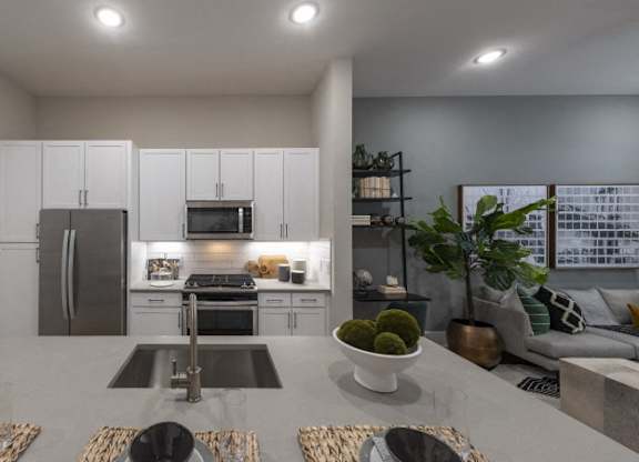 A modern kitchen with a dining table set for four.