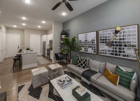 A modern living room with a grey sofa and a coffee table.