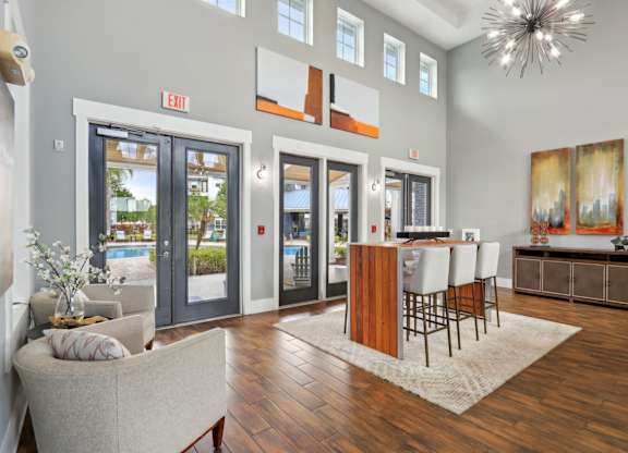 A living room with a couch, chairs, and a dining table.