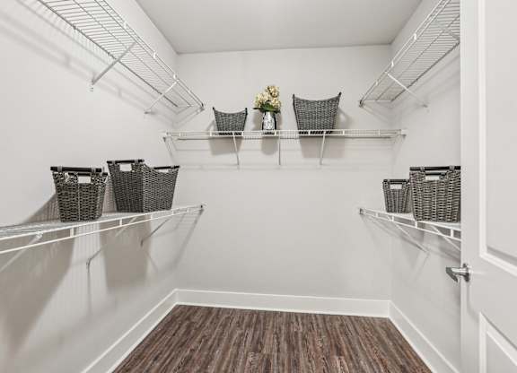 A white pantry with shelves and baskets.