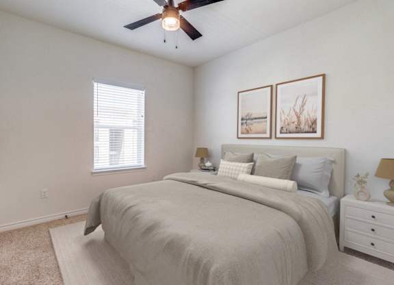 an expansive bedroom with a large bed and a ceiling fan