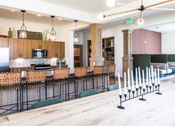 A modern kitchen with a long bar and a dining table.