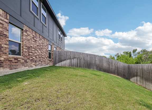 A house with a wooden fence in front of it.