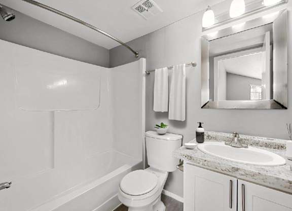 a white bathroom with a sink and a toilet