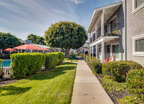 A sunny day at a residential area with apartment buildings and greenery.