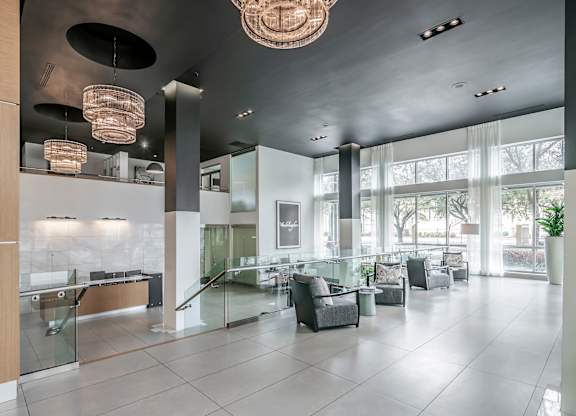 A spacious lobby with a reception desk and comfortable seating areas.