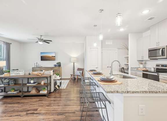 A kitchen with a counter and a sink.