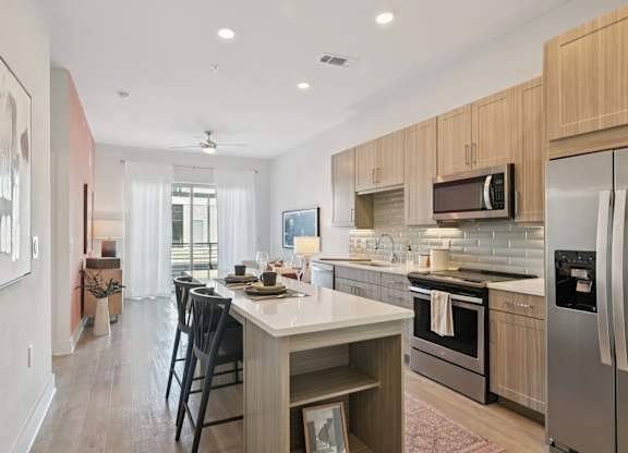 A modern kitchen with a dining table and chairs.
