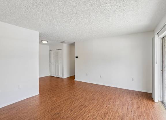 A room with wooden floors and white walls.