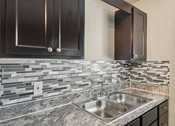 A kitchen with a sink and cabinets.
