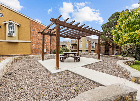 a picnic area with a picnic table in a courtyard