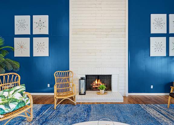 a living room with a fireplace and blue walls