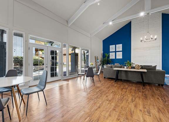 a living room with a dining room table and a couch