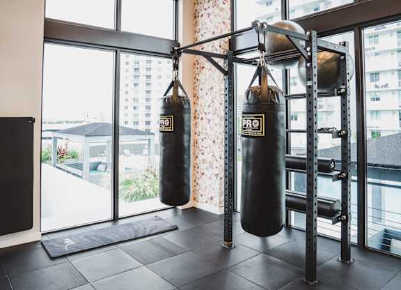 A gym with a punching bag and a speaker.