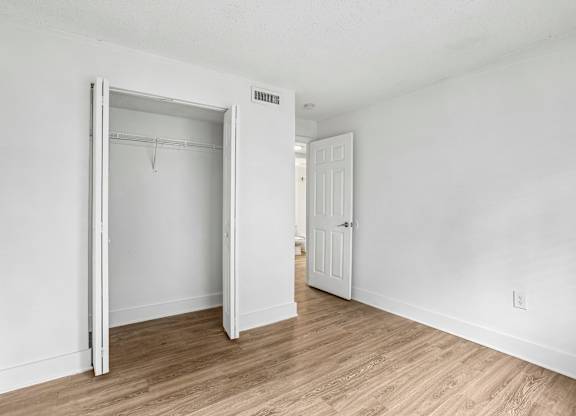 A room with a white door and a white wall.