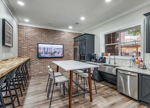 a kitchen with stainless steel appliances and a table with chairs