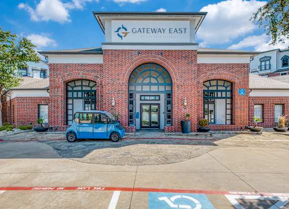 the exterior of the gateway east building with a blue car parked in front of it
