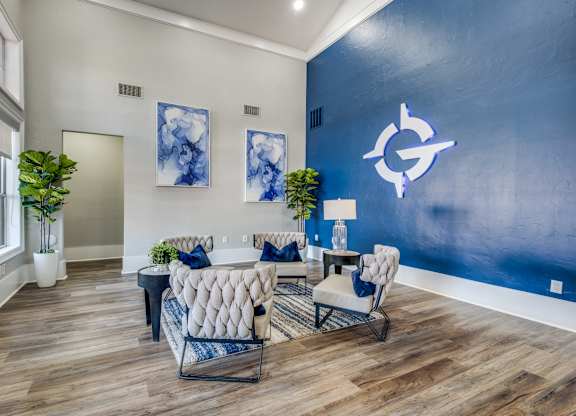 a living room with a blue wall and white furniture