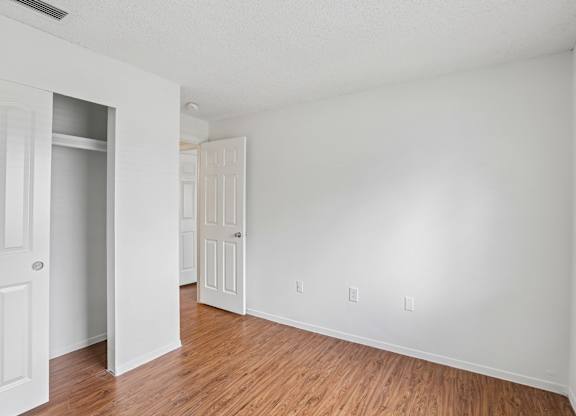 A room with white walls and wooden flooring.