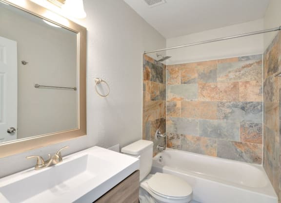a bathroom with a sink toilet and a shower