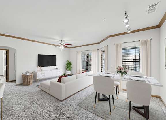 A living room with a white couch and a dining table set up.