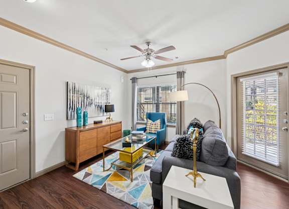 A living room with a grey couch and a yellow coffee table.
