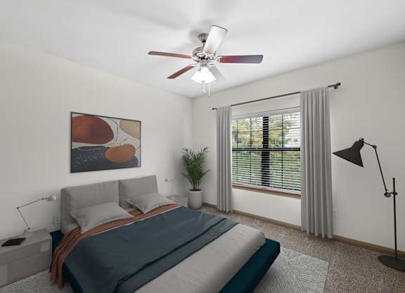 A bedroom with a bed, a ceiling fan, and a window with a plant.