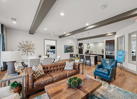 A living room with a brown couch and a blue chair.