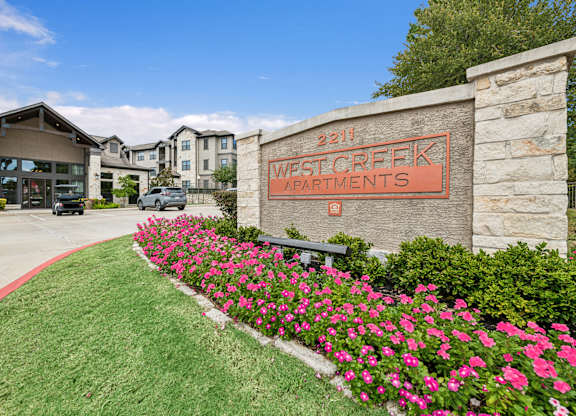 West Creek Apartments is a beautiful apartment complex with a well-maintained garden in front.