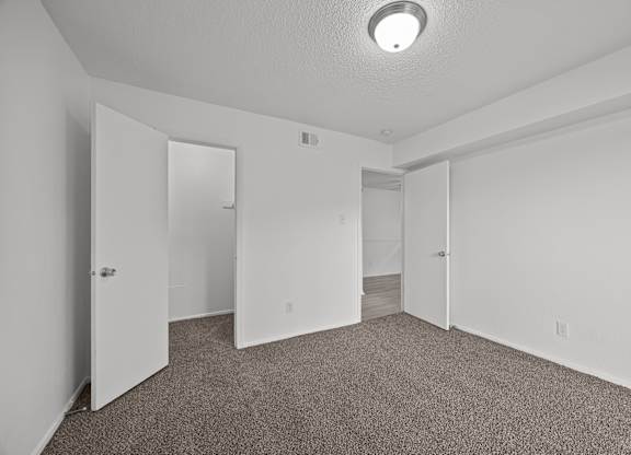 A room with carpeted floor and white walls.