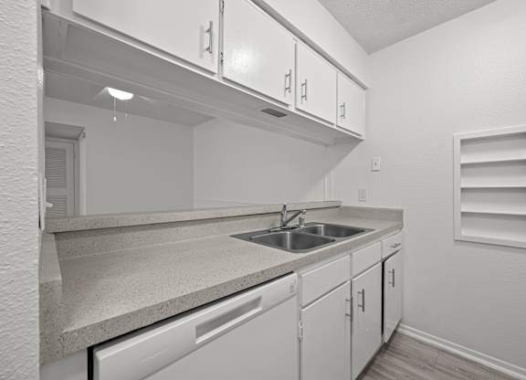 A kitchen with white cabinets and a countertop.