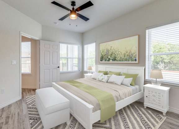 a bedroom with a large bed and a ceiling fan