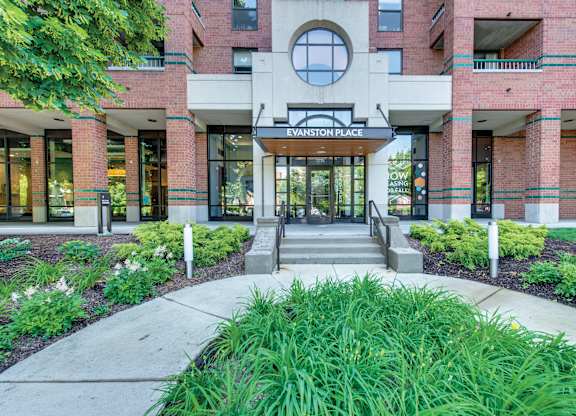 The entrance of Evanston Place Apartments with greenery.