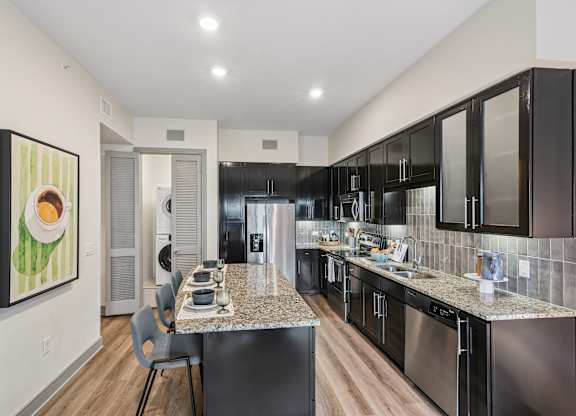 A modern kitchen with a dining table and chairs.