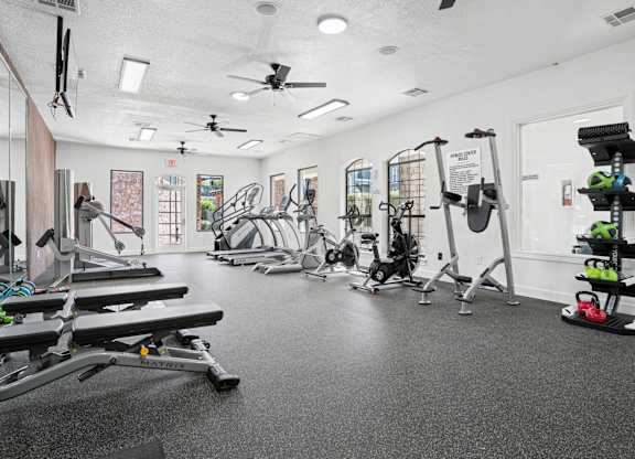 A spacious gym with a variety of equipment including treadmills, weights, and exercise machines.