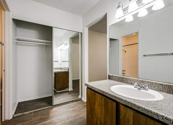 the interior of a bathroom with a sink and a mirror