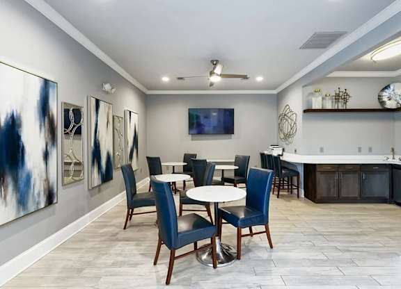 A dining room with a table set for four.
