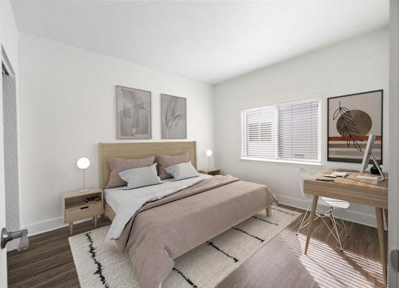 A bedroom with a bed, desk, and chair.
