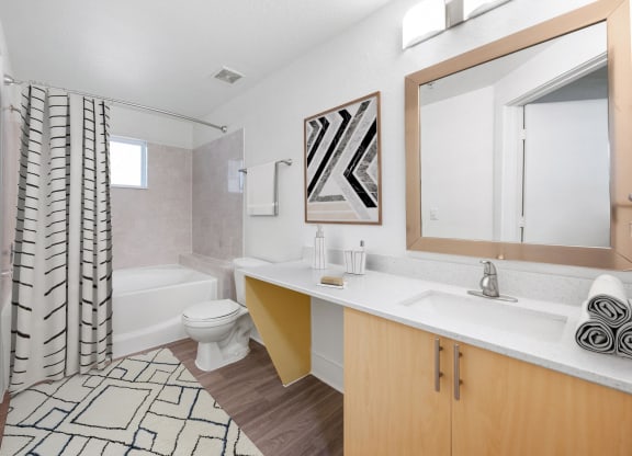 a bathroom with a tub and a sink and a toilet