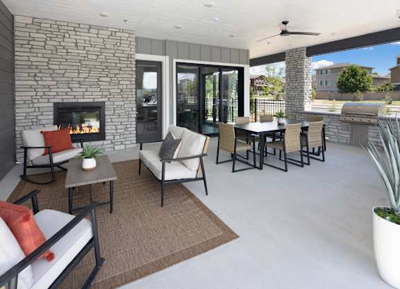 A patio with a fireplace and furniture.